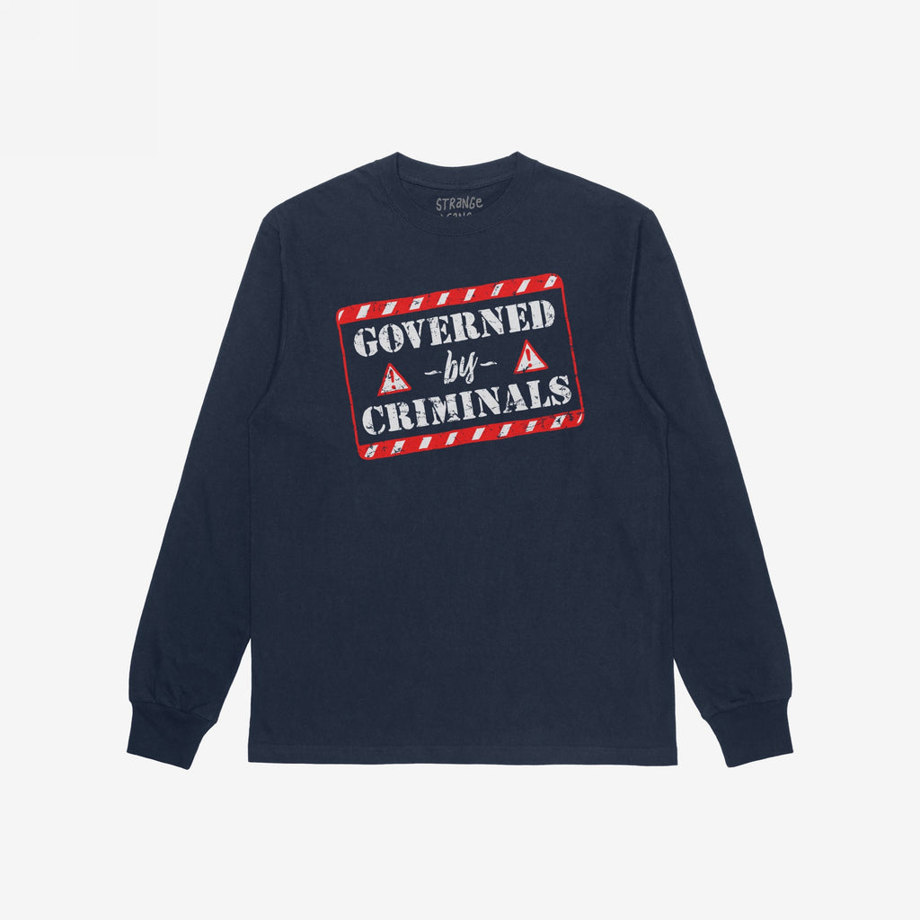 Navy-blue long-sleeve T-shirt with “Governed By Criminals” in distressed stencil lettering, featuring red-bordered warning graphics, symbolizing resistance against political corruption.