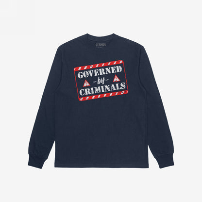 Navy-blue long-sleeve Governed By Criminals T-shirt featuring a stencil-style graphic with red hazard stripes, challenging corruption with a bold message. Ideal for protests or conversations on inequality and power.
