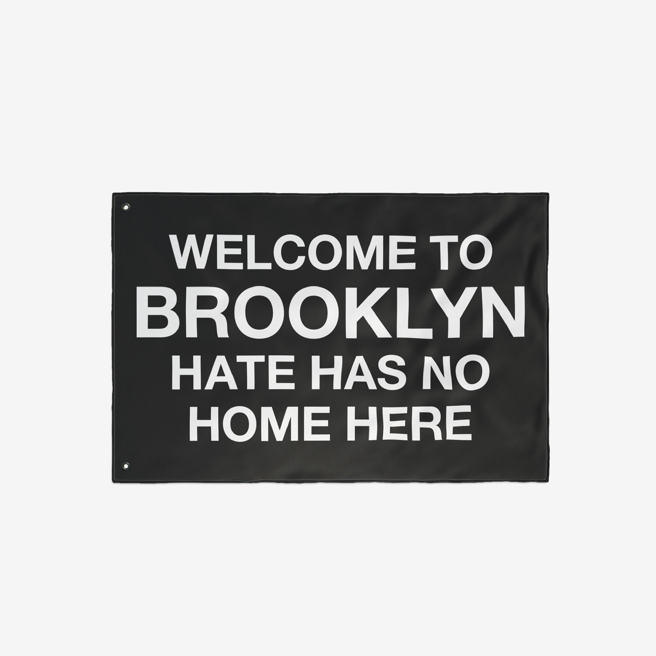 Black flag with bold white text: WELCOME TO BROOKLYN HATE HAS NO HOME HERE. The Custom Hate Has No Home Here Flag promotes justice and equality, customizable for your city or neighborhood.
