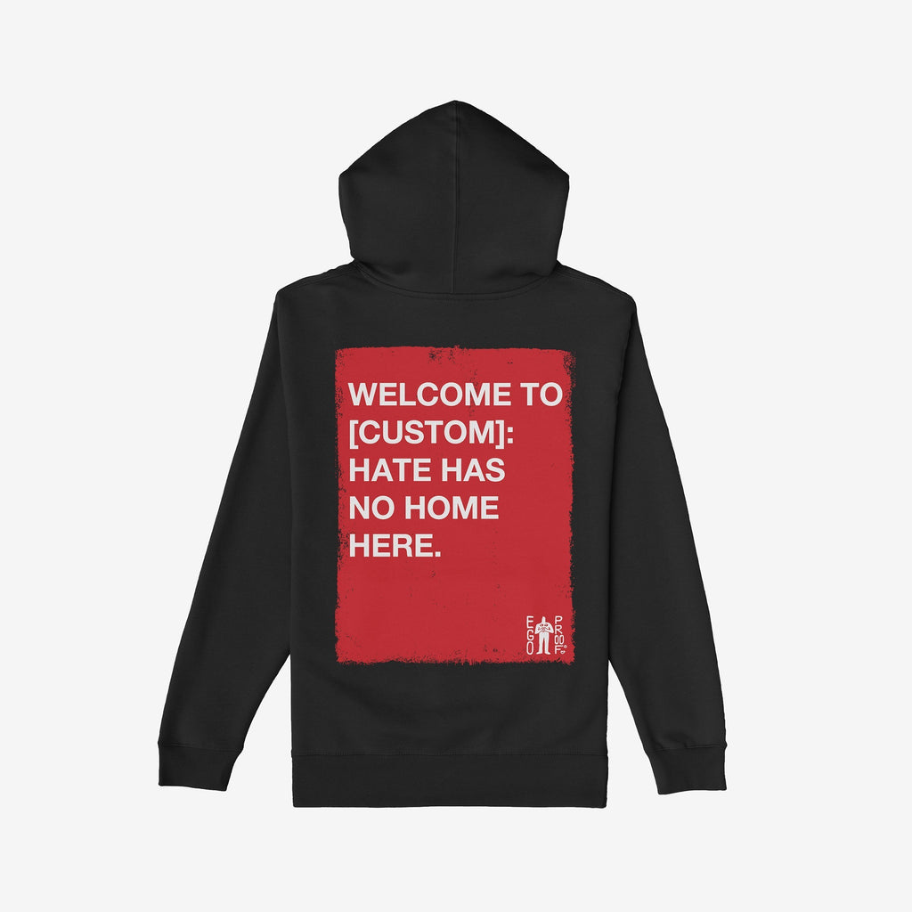 Back-view of the Custom Hate Has No Home Here Hoodie, featuring a red rectangle with white text promoting unity. Includes a small logo and customizable city name for personalized activism.