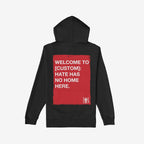 Back-view of the Custom Hate Has No Home Here Hoodie, featuring a red rectangle with white text promoting unity. Includes a small logo and customizable city name for personalized activism.