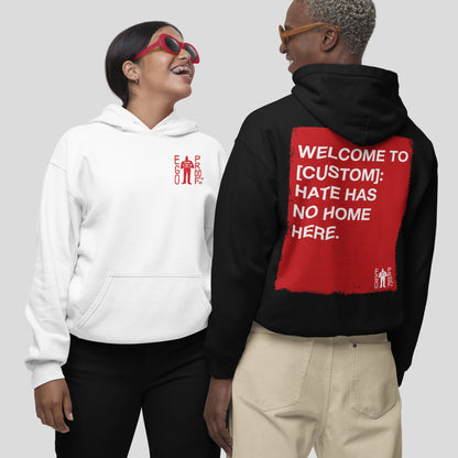 Two people wearing “Custom Hate Has No Home Here Hoodie”; one in a white hoodie with a small “EGO PROD.” logo, the other in a black hoodie featuring a bold, customizable community message on the back.