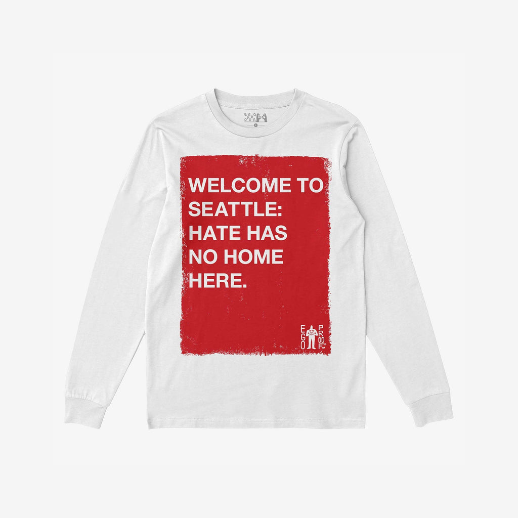 Custom Hate Has No Home Here Long Sleeve T-shirt featuring a bold red square with a message against hate, emphasizing community and equality. Ideal for activism, with “EGO PROOF” logo in the corner.