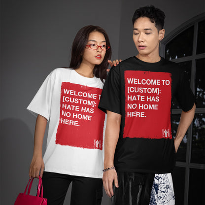 Two young adults model Custom Hate Has No Home Here T-shirts, featuring customizable red graphics promoting inclusivity. Perfect for showcasing justice and equality, aligning with the store's advocacy for change.