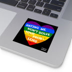 Silver laptop corner with a visible keyboard features a No LGBTQ Hate sticker, showcasing a distressed rainbow heart with Hating Me Won’t Solve Your Problems, highlighting LGBTQ+ allyship and resilience.