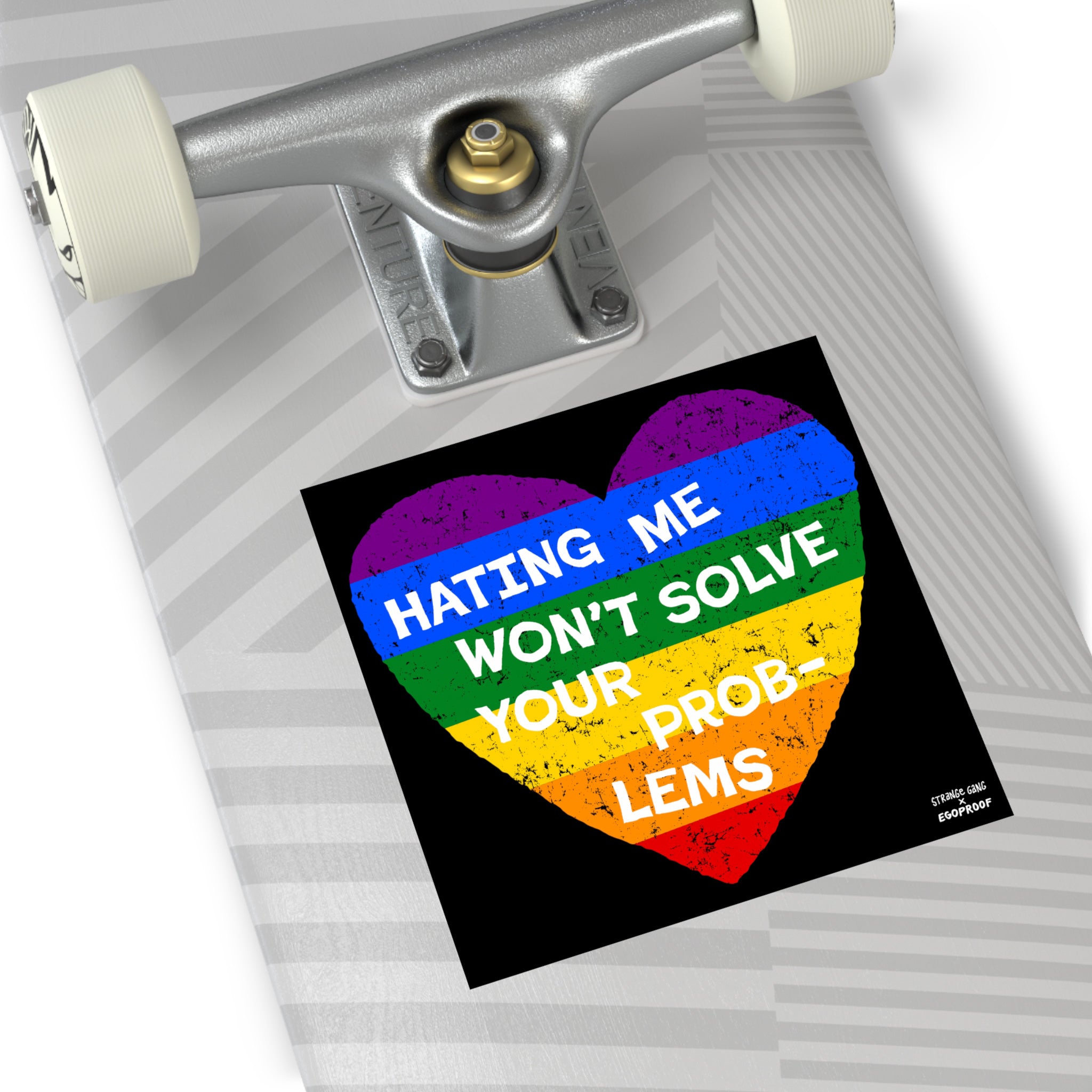 Skateboard deck with Venture trucks featuring a No LGBTQ Hate Sticker & Magnet, a rainbow heart with text HATING ME WON’T SOLVE YOUR PROB-LEMS, symbolizing allyship and resilience.