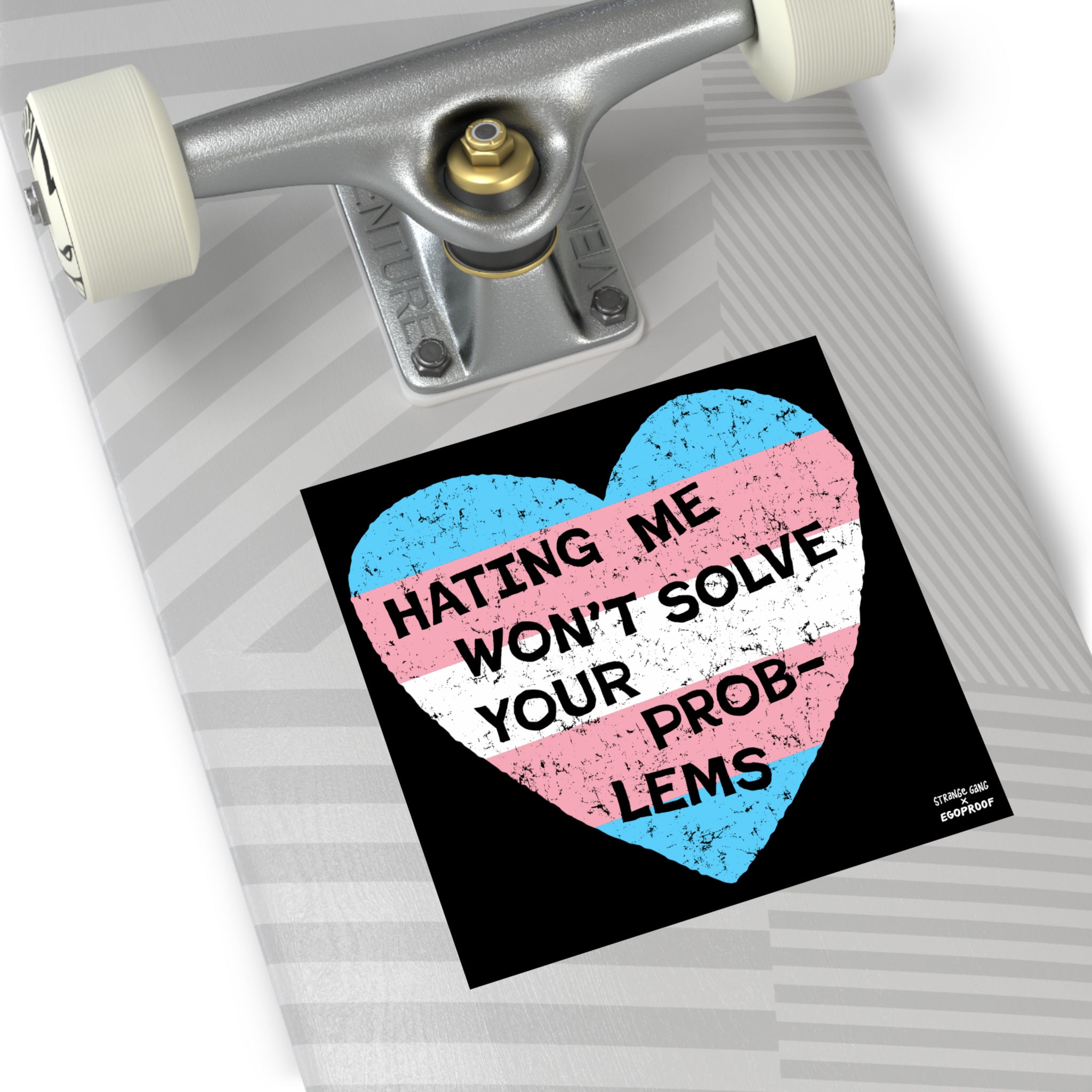 The No Trans Hate Sticker & Magnet features a distressed heart with the transgender pride flag and bold text: “HATING ME WON’T SOLVE YOUR PROB-LEMS,” emphasizing trans pride and resilience.