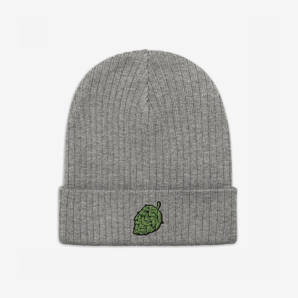 The Hop Nug Hat is a light-gray rib-knit beanie with a folded cuff, featuring a green hop cone embroidered on the center, perfect for craft beer enthusiasts with casual confidence.