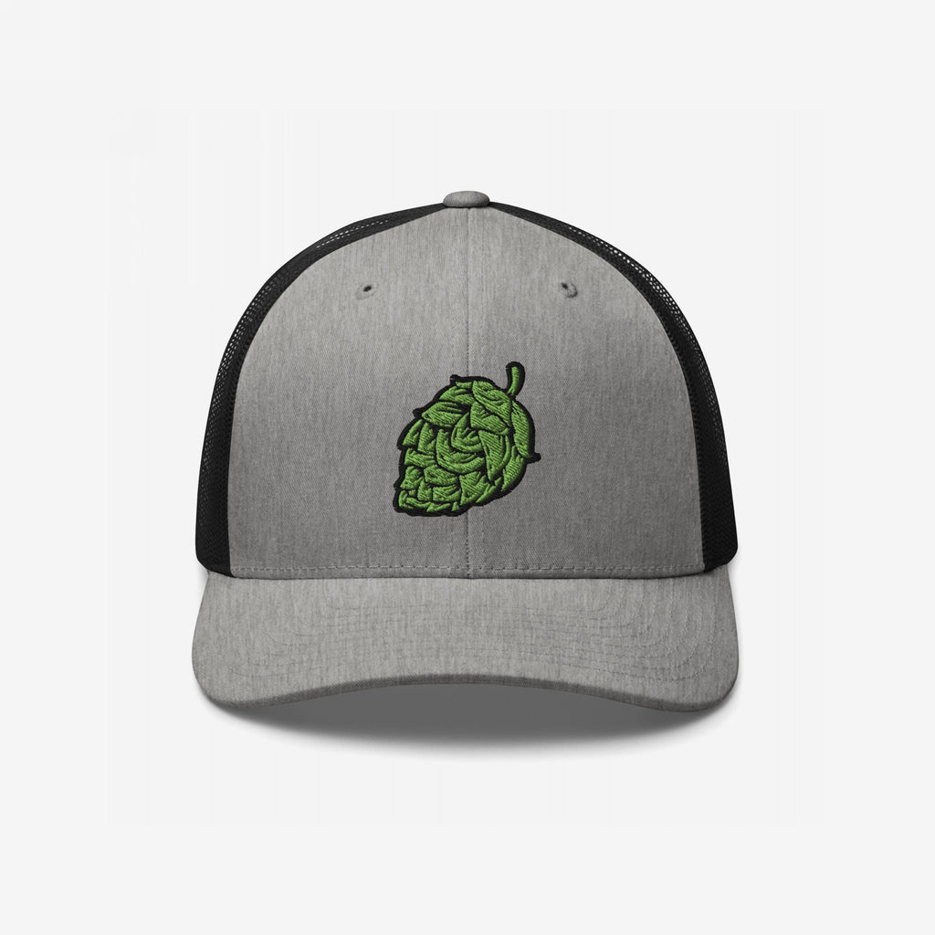 Hop Nug Hat: A stylish trucker cap with a gray front and black mesh back, featuring an embroidered green hop cone. Ideal for craft beer enthusiasts who appreciate casual, confident style.