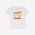 Hopium Shirt: A whimsical white tee showcasing vibrant red and yellow pill characters under Surviving on HOPIUM, perfect for embracing optimism and quirky individuality. Benefits NAMI. Available in various styles.