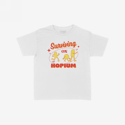 Hopium T-shirt with retro graphic: 'Surviving on Hopium' in red and yellow, featuring playful hop-cone characters, embodying a humorous, optimistic spirit perfect for dreamers and believers.