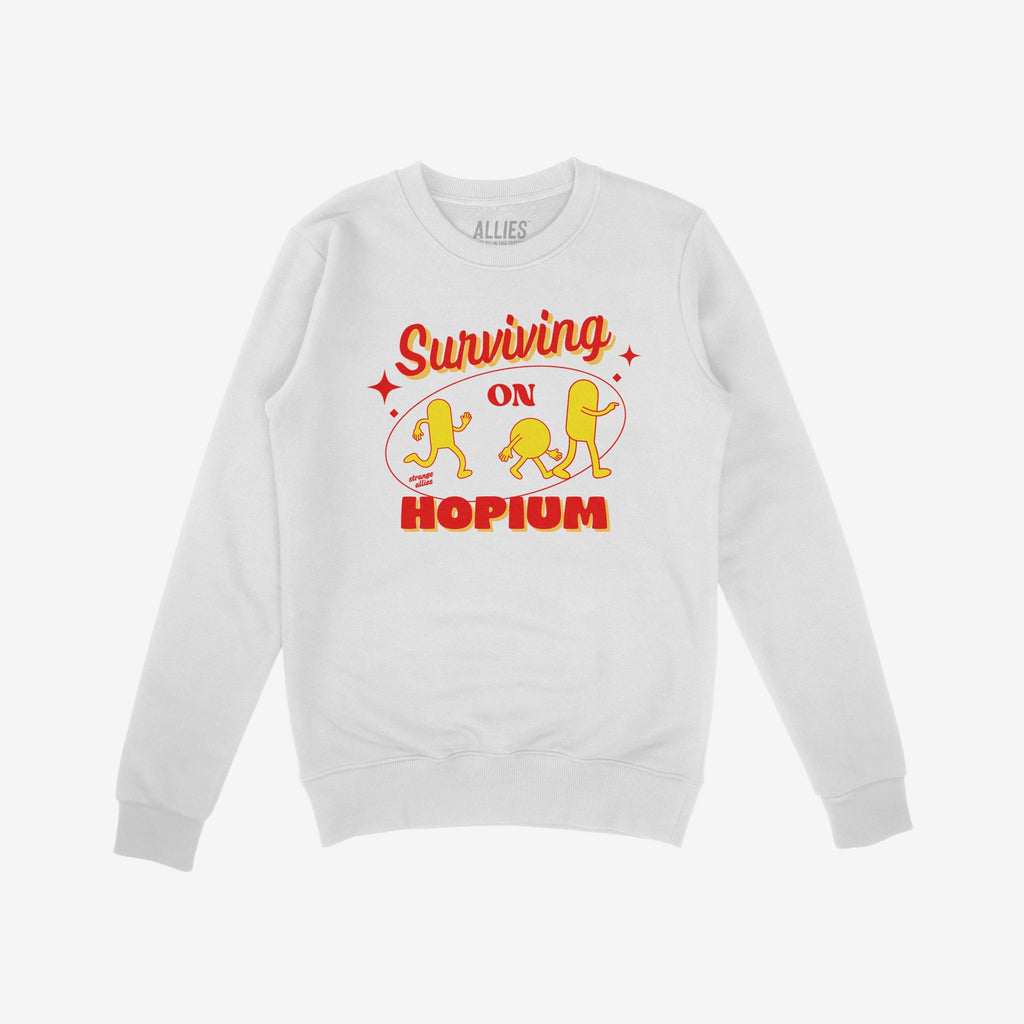 The Hopium Shirt features a white crewneck sweatshirt with Surviving on HOPIUM in bold red and yellow, plus three yellow cartoon figures, embodying whimsical defiance and idealistic optimism.