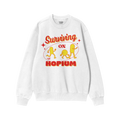 The Hopium Shirt features a white crewneck sweatshirt with Surviving on HOPIUM in bold red and yellow, plus three yellow cart