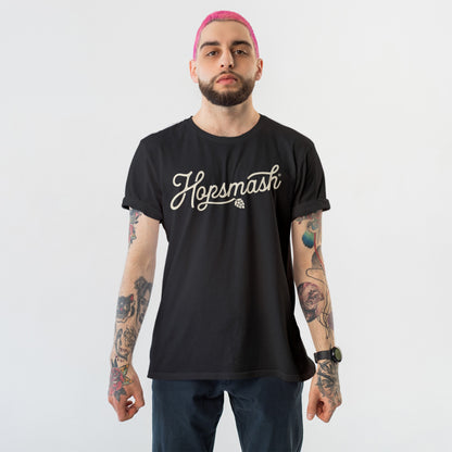Hopsmash T-shirt worn by a young adult with pink hair and tattooed arms, embodying a bold, rebellious style in line with the store's advocacy for equality and self-expression.