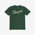Forest-green Hopsmash T-shirt featuring a cream-colored, flowing script logo with a hop-cone graphic. Ideal for IPA enthusiasts, this tee embodies boldness and a passion for craft beer culture.