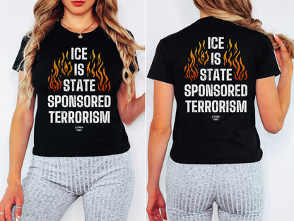 Woman modeling the ICE Is State Sponsored Terrorism Women's Baby Tee featuring bold white text and orange flames, paired with light gray leggings, showcasing the tee's front and back statement design.
