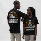Two individuals wear the ICE Is State Sponsored Terrorism Shirt, displaying the slogan in bold letters and orange flames, highlighting its activist message against a plain background.