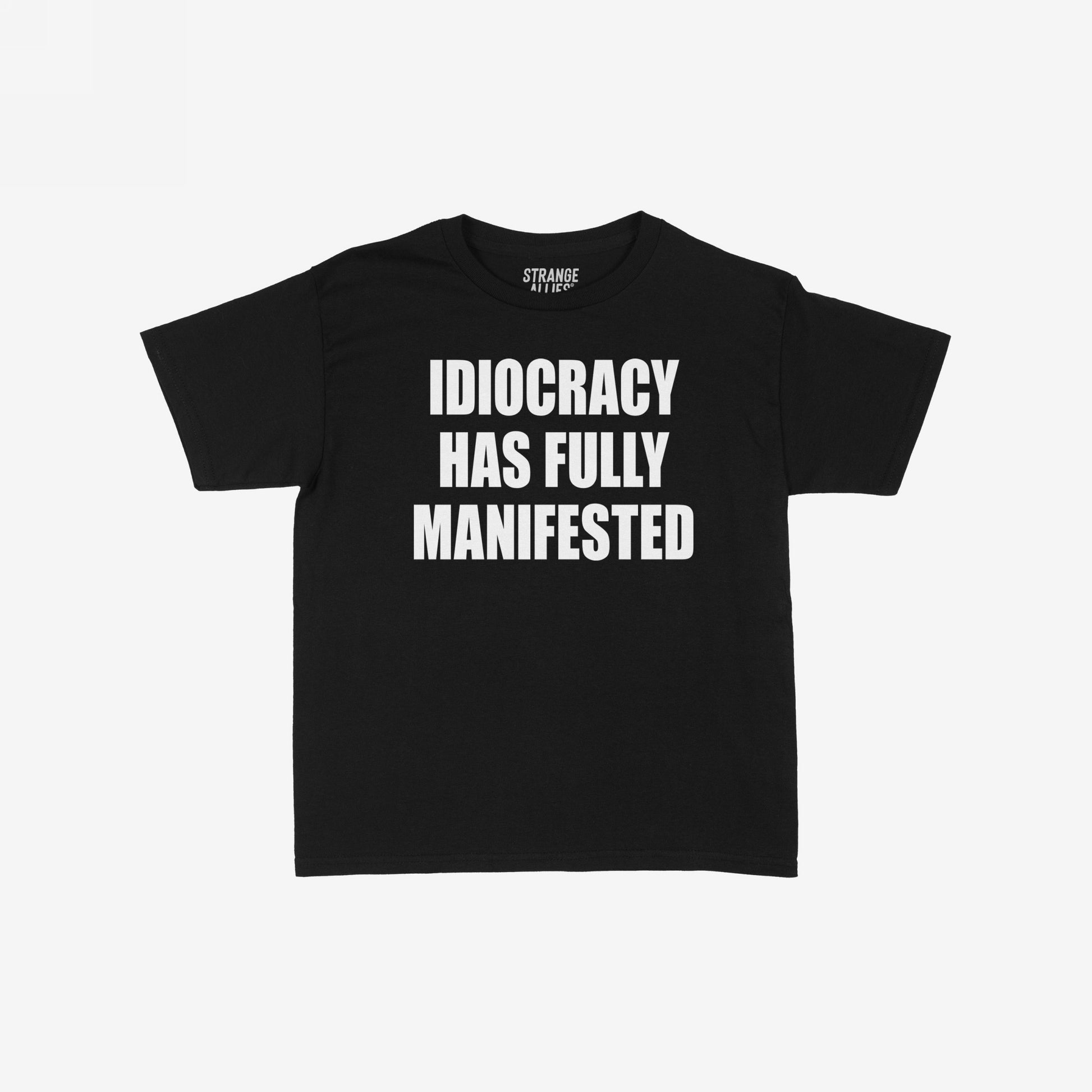 Idiocracy Women's Baby Tee features bold white text IDIOCRACY HAS FULLY MANIFESTED on a black T-shirt, highlighting societal critique with a nod to the cult classic film.