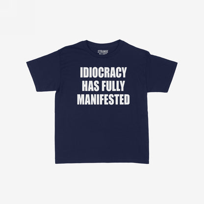 The Idiocracy Women's Baby Tee displays bold white text stating IDIOCRACY HAS FULLY MANIFESTED, capturing a satirical nod to societal commentary, ideal for expressive, thought-provoking casual wear.