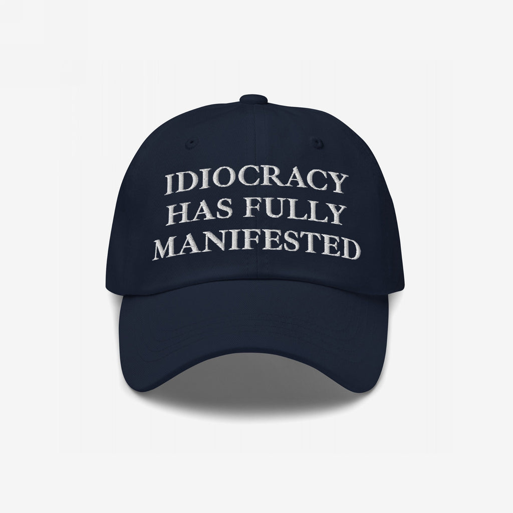Navy-blue Idiocracy Hat with IDIOCRACY HAS FULLY MANIFESTED embroidered in white serif letters, reflecting bold social commentary and aligning with the store's advocacy for equality and justice.