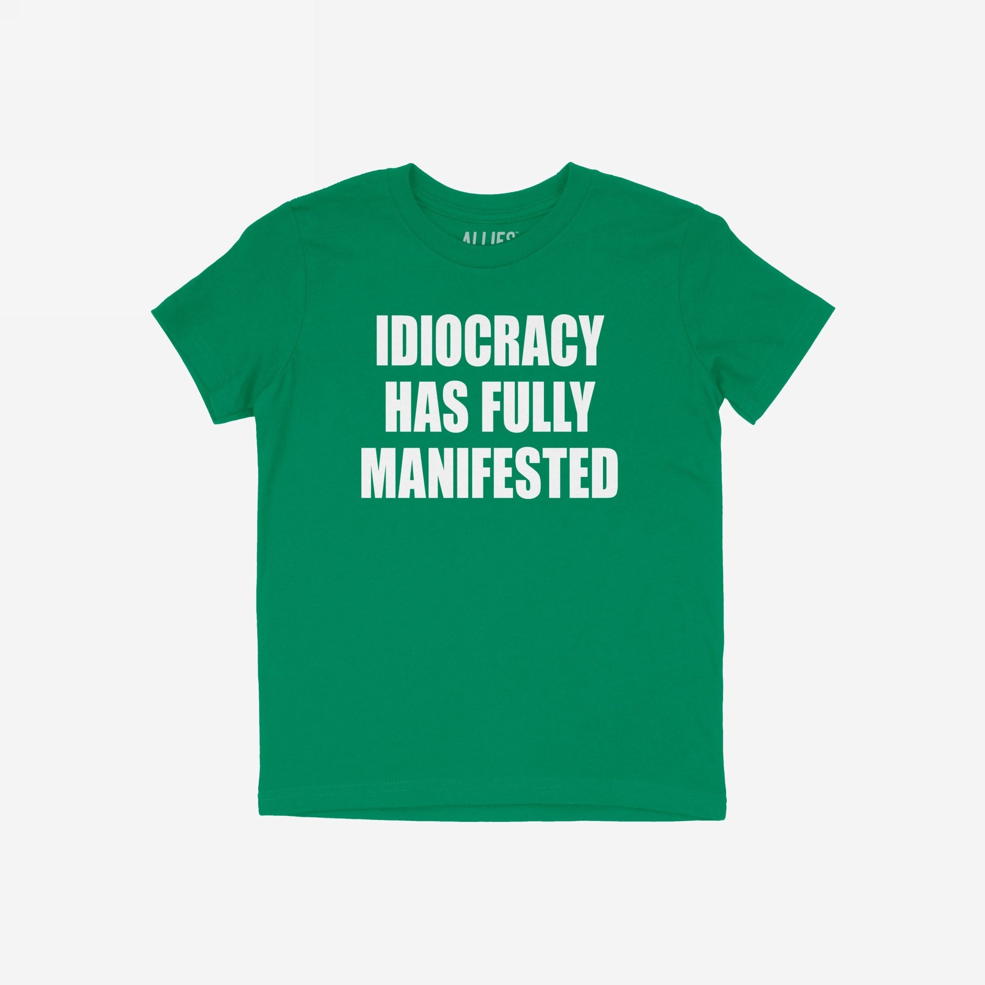 Green Idiocracy T-shirt with bold white text, “IDIOCRACY HAS FULLY MANIFESTED.”, reflecting a blunt statement for the politically disillusioned, embodying the spirit of resistance and truth with wit.