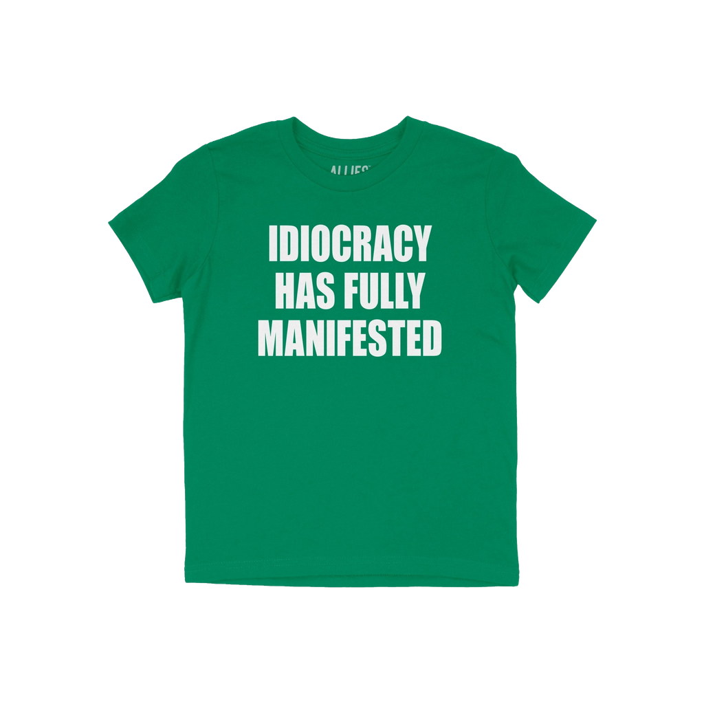 Green Idiocracy T-shirt with bold white text, “IDIOCRACY HAS FULLY MANIFESTED.”, reflecting a blunt statement for the pol