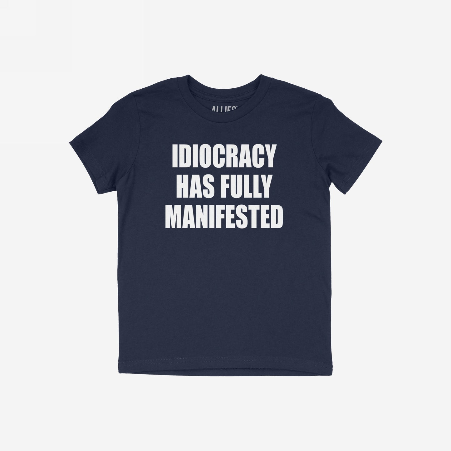 The Idiocracy T-shirt features a bold white slogan declaring “IDIOCRACY HAS FULLY MANIFESTED,” capturing the essence of modern disillusionment and cultural critique.
