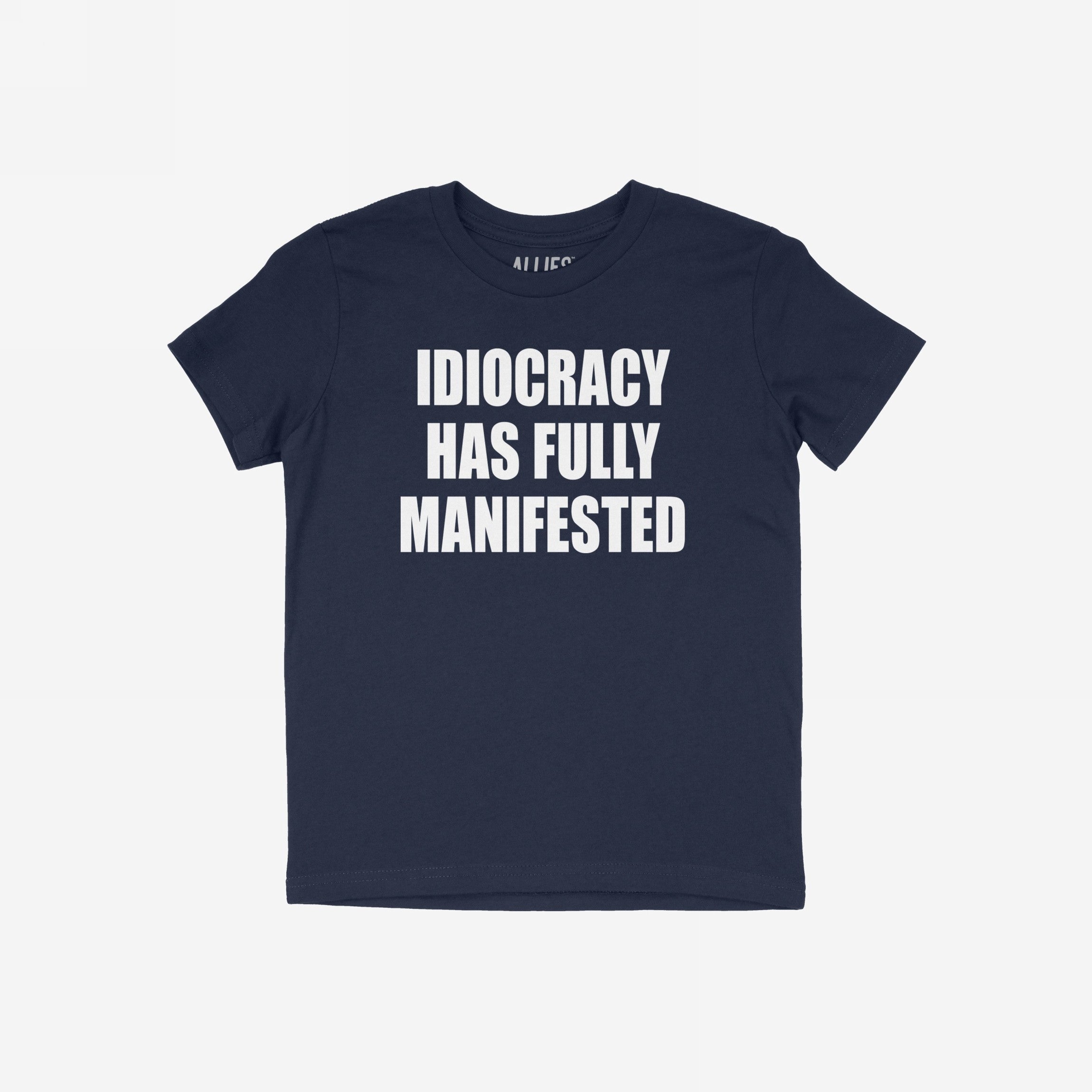 The Idiocracy T-shirt features a bold white slogan declaring “IDIOCRACY HAS FULLY MANIFESTED,” capturing the essence of modern disillusionment and cultural critique.