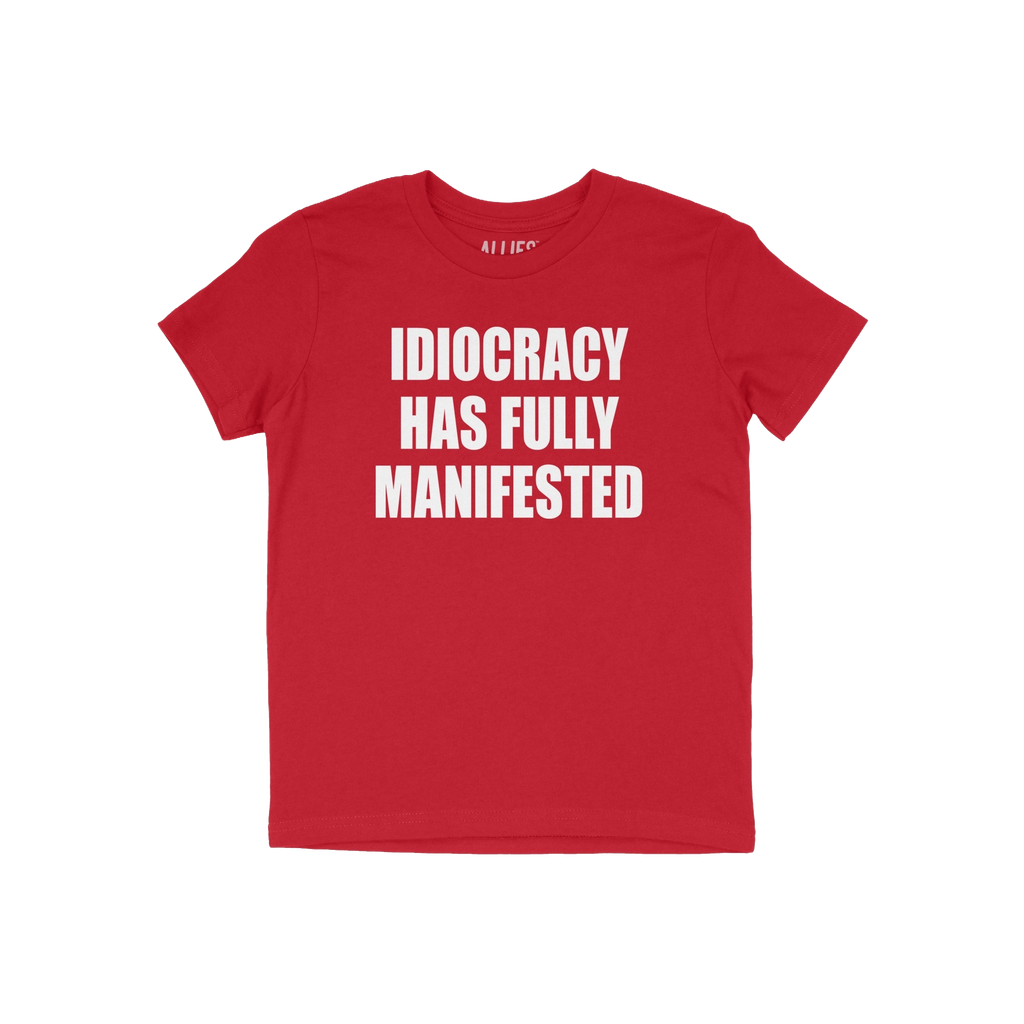 Red T-shirt with bold white text: IDIOCRACY HAS FULLY MANIFESTED. The Idiocracy T-shirt delivers a stark message, suited for