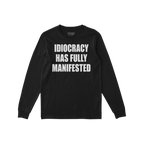 Black long-sleeve Idiocracy T-shirt features bold white text stating, IDIOCRACY HAS FULLY MANIFESTED, embodying a blunt socie