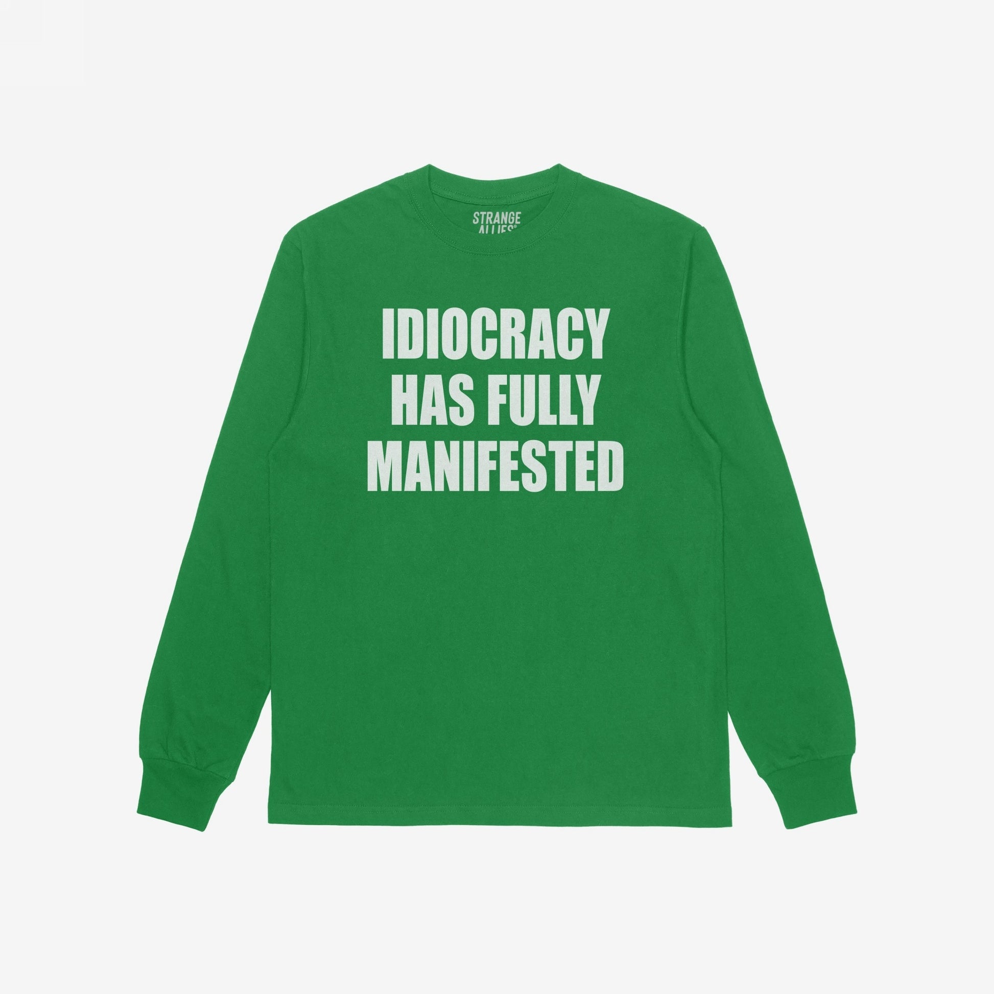 Green long-sleeve Idiocracy T-shirt features bold white lettering stating “IDIOCRACY HAS FULLY MANIFESTED. Ideal for those embracing political disillusionment with a touch of humor and truth.