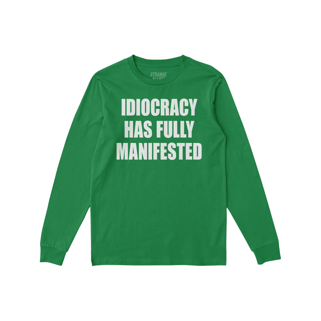 Green long-sleeve Idiocracy T-shirt features bold white lettering stating “IDIOCRACY HAS FULLY MANIFESTED. Ideal for those 