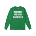Green long-sleeve Idiocracy T-shirt features bold white lettering stating “IDIOCRACY HAS FULLY MANIFESTED. Ideal for those 