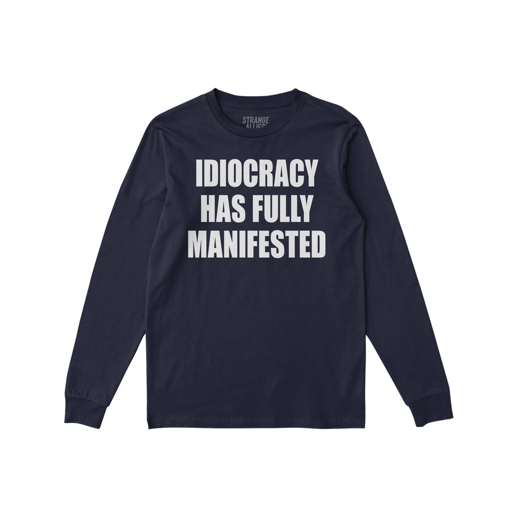 Navy-blue Idiocracy T-shirt with “IDIOCRACY HAS FULLY MANIFESTED.” printed in white on the front, reflecting a bold, poli