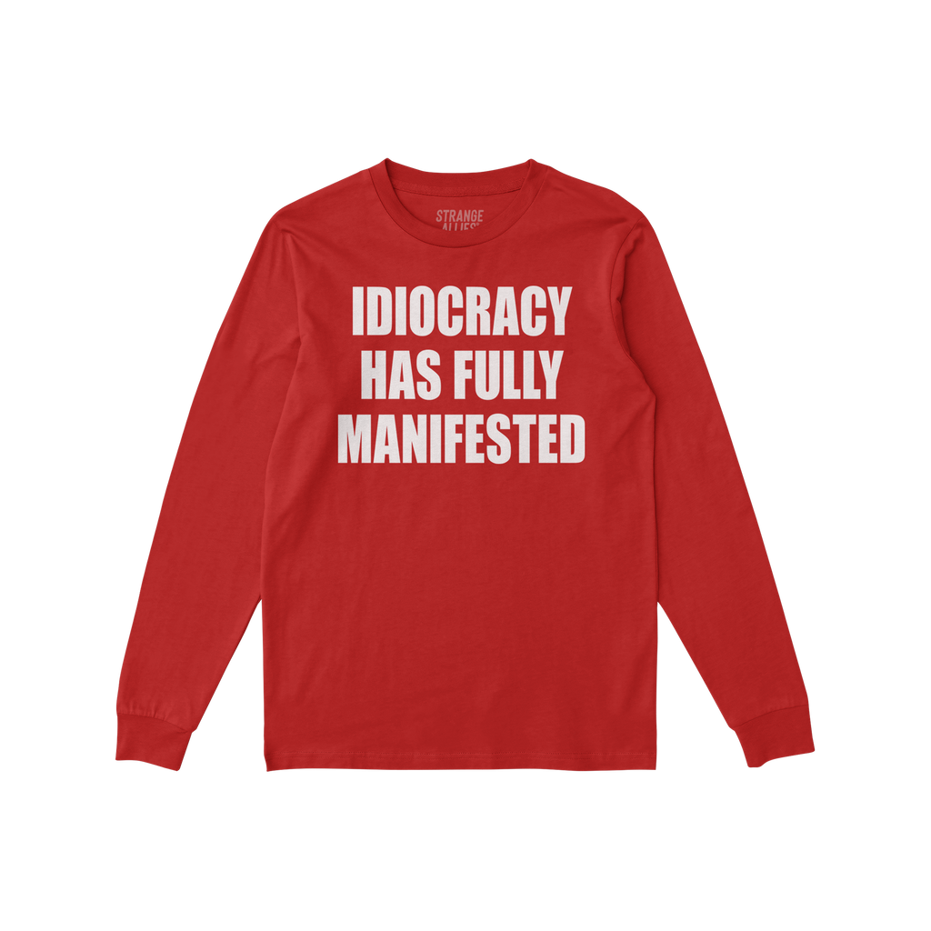 Idiocracy T-shirt in red with bold white slogan IDIOCRACY HAS FULLY MANIFESTED on the front, reflecting a sharp, satirical me