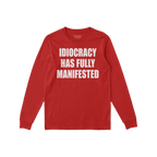 Idiocracy T-shirt in red with bold white slogan IDIOCRACY HAS FULLY MANIFESTED on the front, reflecting a sharp, satirical me