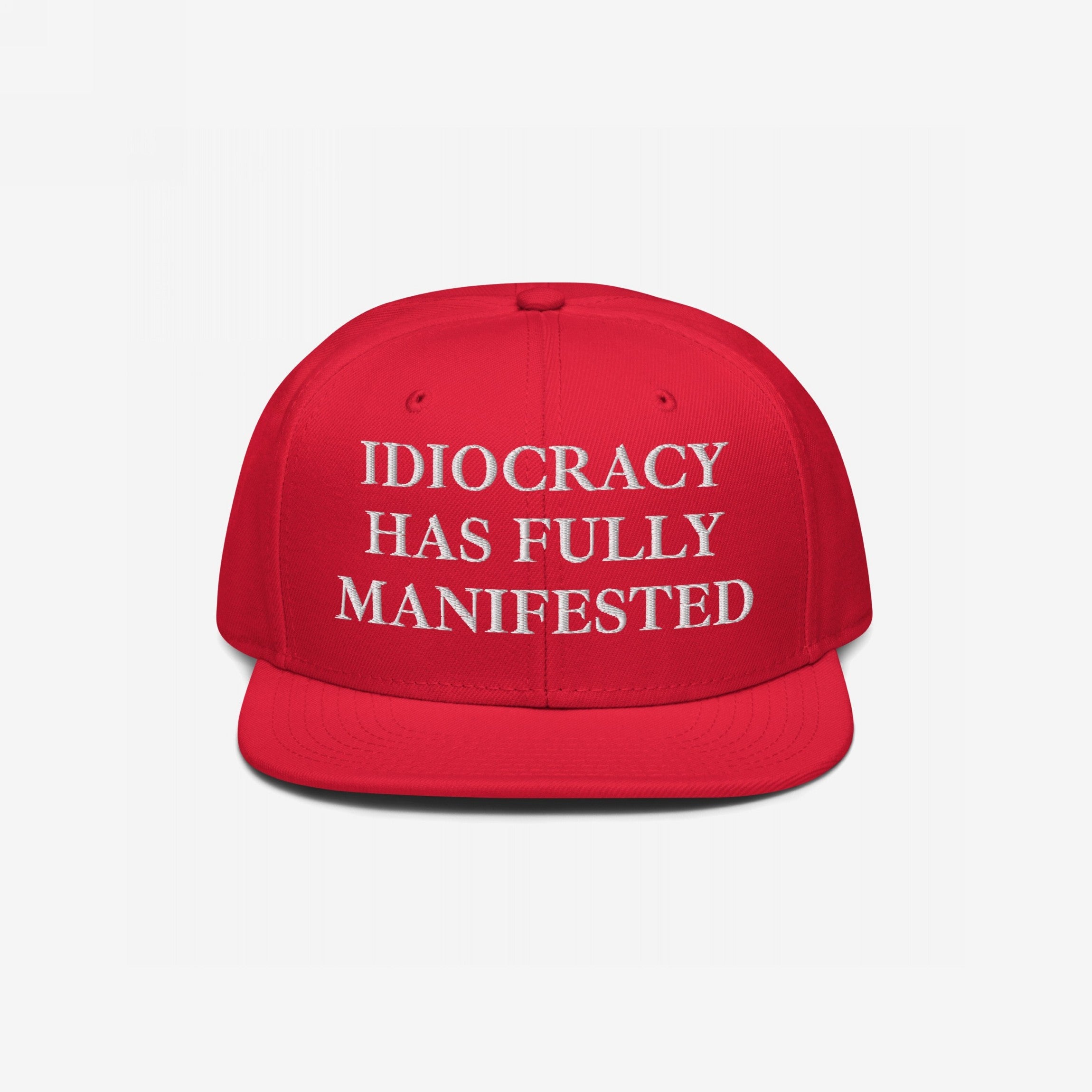 Bright-red Idiocracy Hat with white embroidered text, IDIOCRACY HAS FULLY MANIFESTED, in classic serif type, ideal for those expressing bold social commentary.