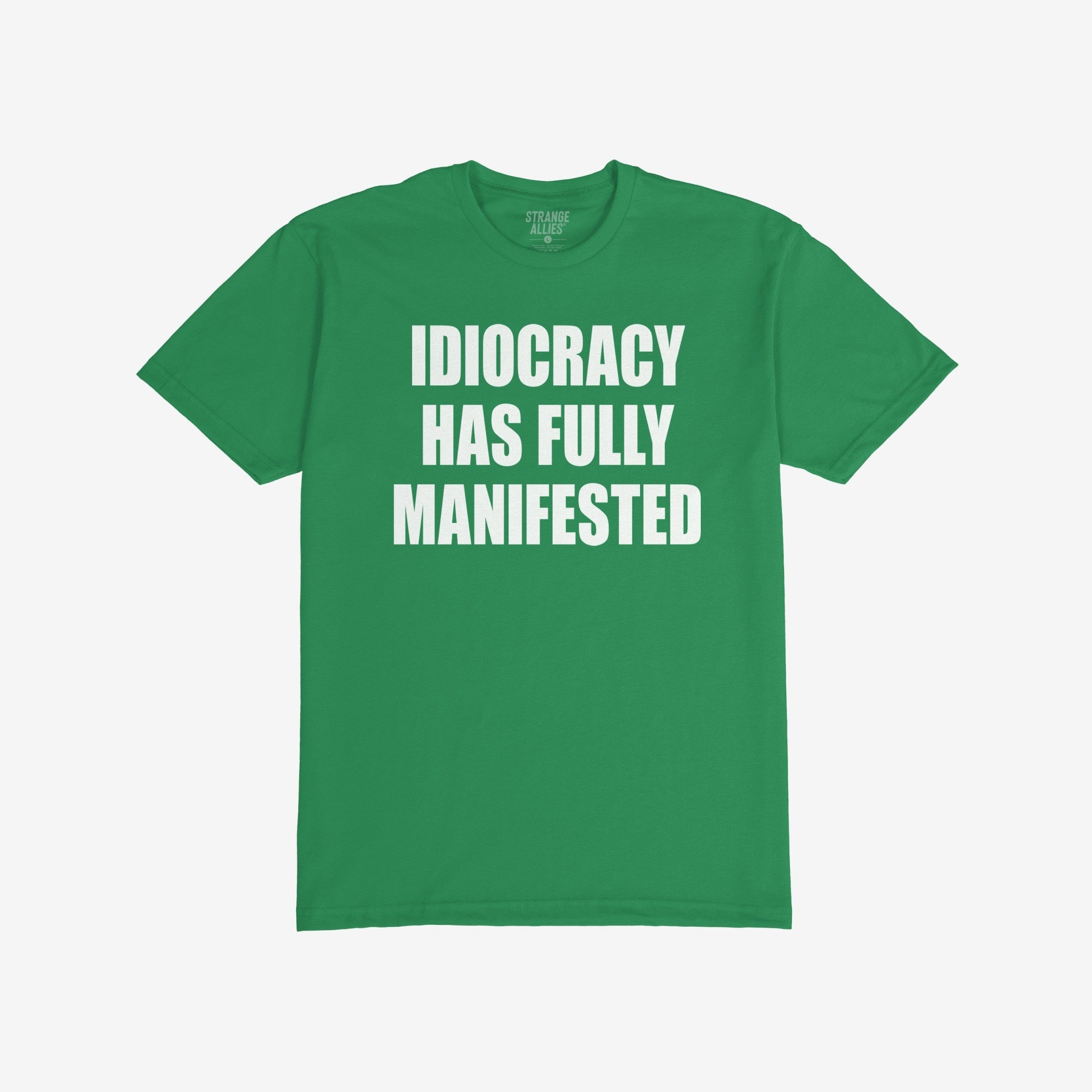 Green, short-sleeved Idiocracy T-shirt features bold white text stating “IDIOCRACY HAS FULLY MANIFESTED”, reflecting a satirical take on current events, ideal for the politically disillusioned and meme enthusiasts.