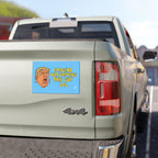 Anti Trump LOL Magnet & Sticker on a light-green pickup's tailgate, featuring a cartoon face and satirical text mocking cult worship, reflecting progressive values with durable, weatherproof design.