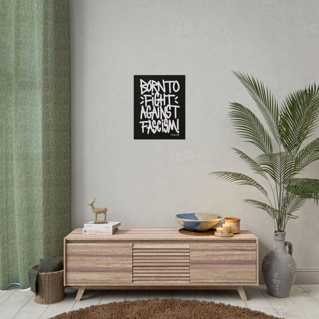 Born To Fight Against Fascism Graffiti Poster hangs above a mid-century sideboard, paired with books, a deer figurine, candles, and a palm frond, embodying protest spirit in a minimalist setting.