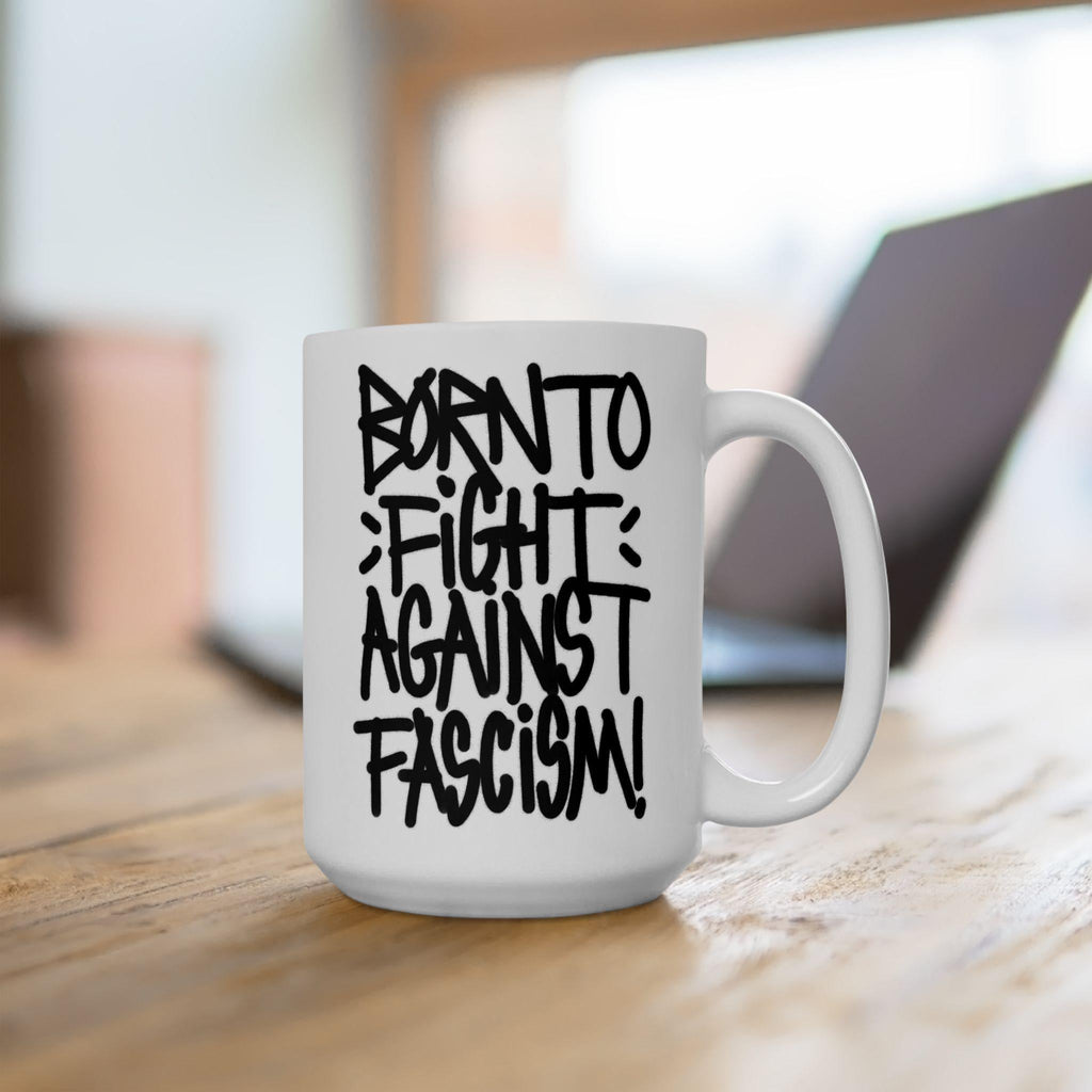 Born To Fight Against Fascism Graffiti Mug on a wooden table, showcasing bold hand-lettered text, blending protest art with functionality; ideal for activists, supporting equality and resistance.