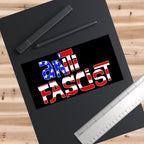 Top-down view of the Anti Fascist USA Sticker & Magnet on a black sketchpad, featuring a stars-and-stripes motif, alongside two digital-stylus pens and a metal ruler.