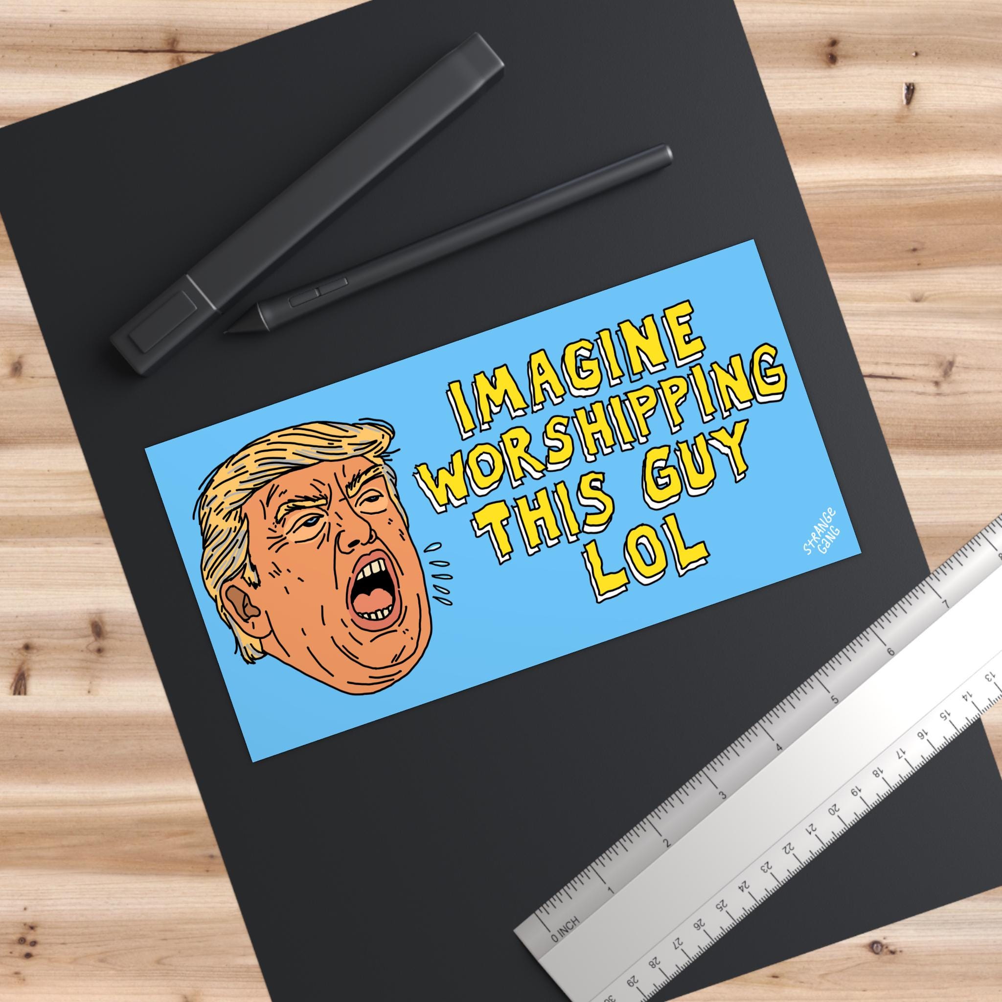 Anti Trump LOL Magnet & Sticker shows a cartoon man’s face with yellow hair, shouting alongside bold text IMAGINE WORSHIPPING THIS GUY LOL, embodying satire against cult worship.