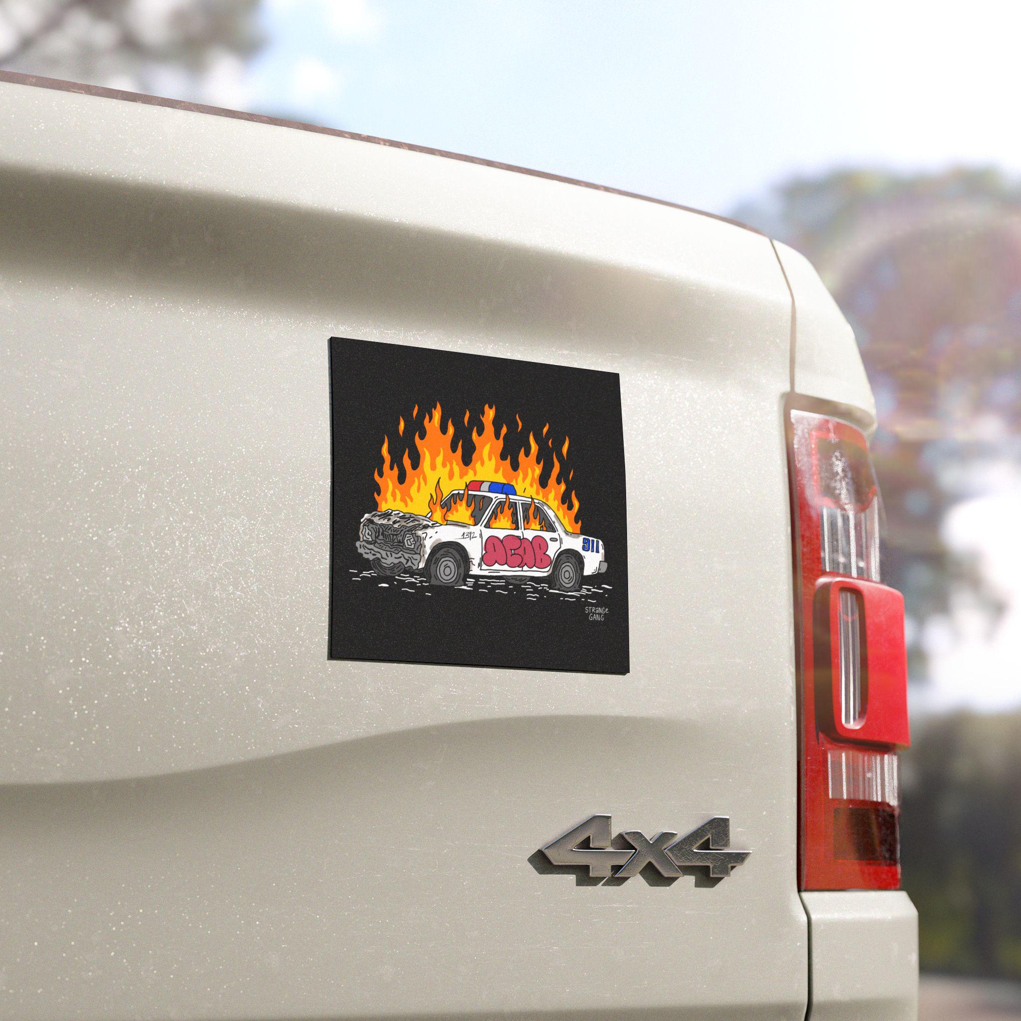 ACAB Police Car Sticker & Magnet on a white 4×4 truck's tailgate, showcasing a hand-drawn burning police car with ACAB graffiti, symbolizing defiance against police brutality and authoritarianism.
