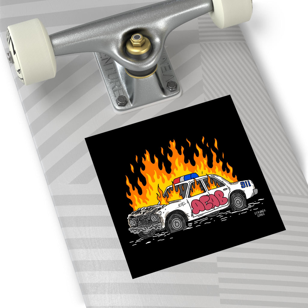 ACAB Police Car Sticker & Magnet on a skateboard deck, featuring a hand-drawn police cruiser engulfed in flames with graffiti ACAB and 911, highlighting resistance against police brutality.