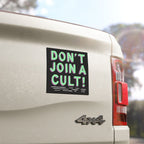 Don't Join A Cult Sticker & Magnet displayed on a white 4x4 truck's tailgate, showcasing bold, hand-drawn green and pink letters, symbolizing resistance against authoritarian ideologies.