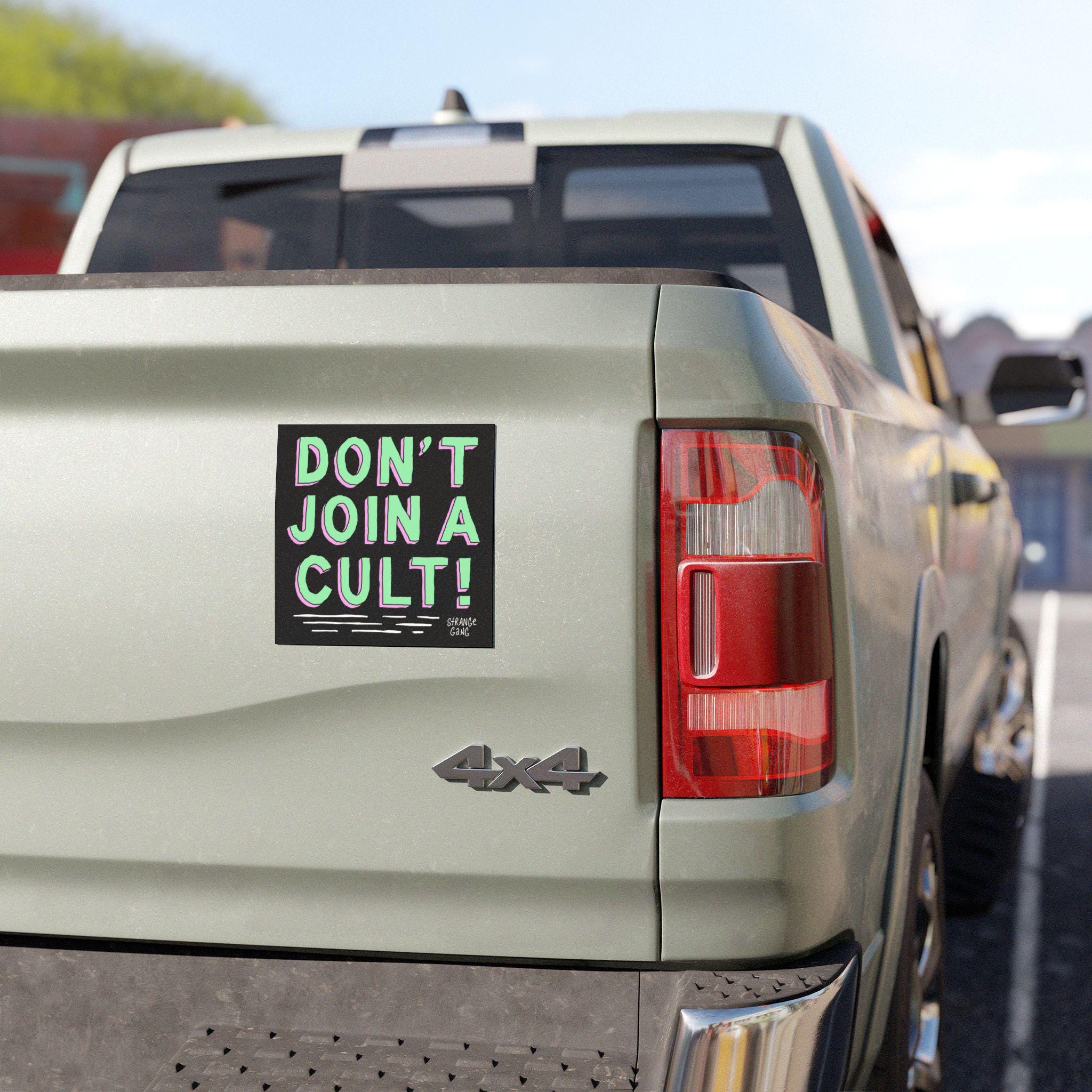 The tailgate features the Don't Join A Cult Sticker & Magnet, showcasing bold lettering critiquing authoritarianism, ideal for highlighting progressive values on vehicles, laptops, or protest gear.