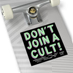 A skateboard deck tail displays the Don't Join A Cult sticker, promoting critical thinking and challenging authoritarianism. The sticker, signed by Strange Gang, advocates equality and resistance to blind allegiance.
