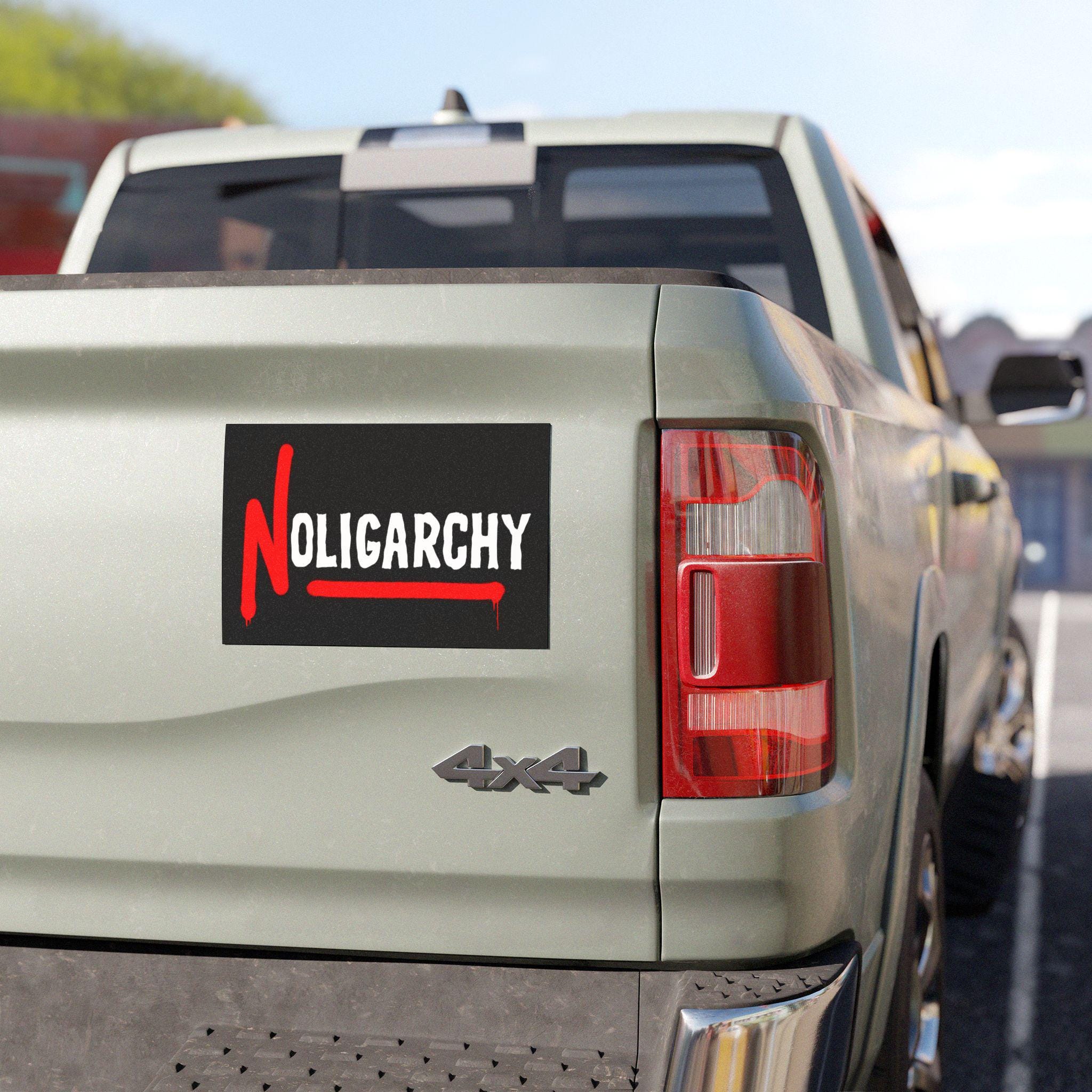 No Oligarchy Sticker & Magnet on a light-green 4x4 truck's tailgate, showcasing bold anti-oligarch message with a stylized red N. Perfect for cars and protest gear.