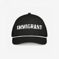 Black trucker-style Immigrant Hat with a white rope detail and IMMIGRANT in distressed font, featuring barbed-wire lines. A bold statement piece for activists, blending style with protest.